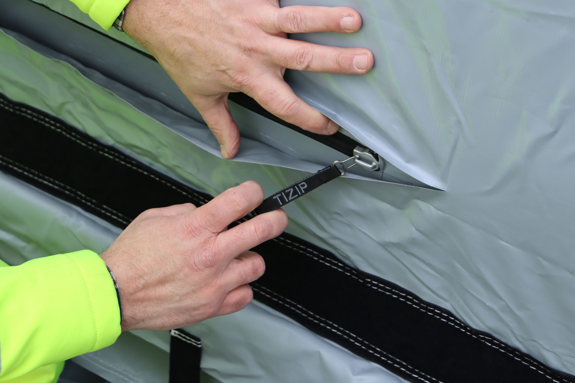TiZIP quick-release zip on the front of an InflatorShield unit — for rapid deflation when the job is done
