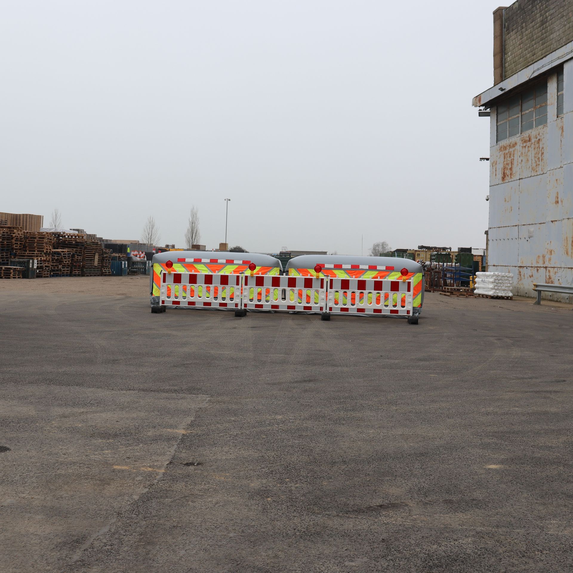 Three InflatorShield units deployed alongside standard road barriers forming a complete lane closure system