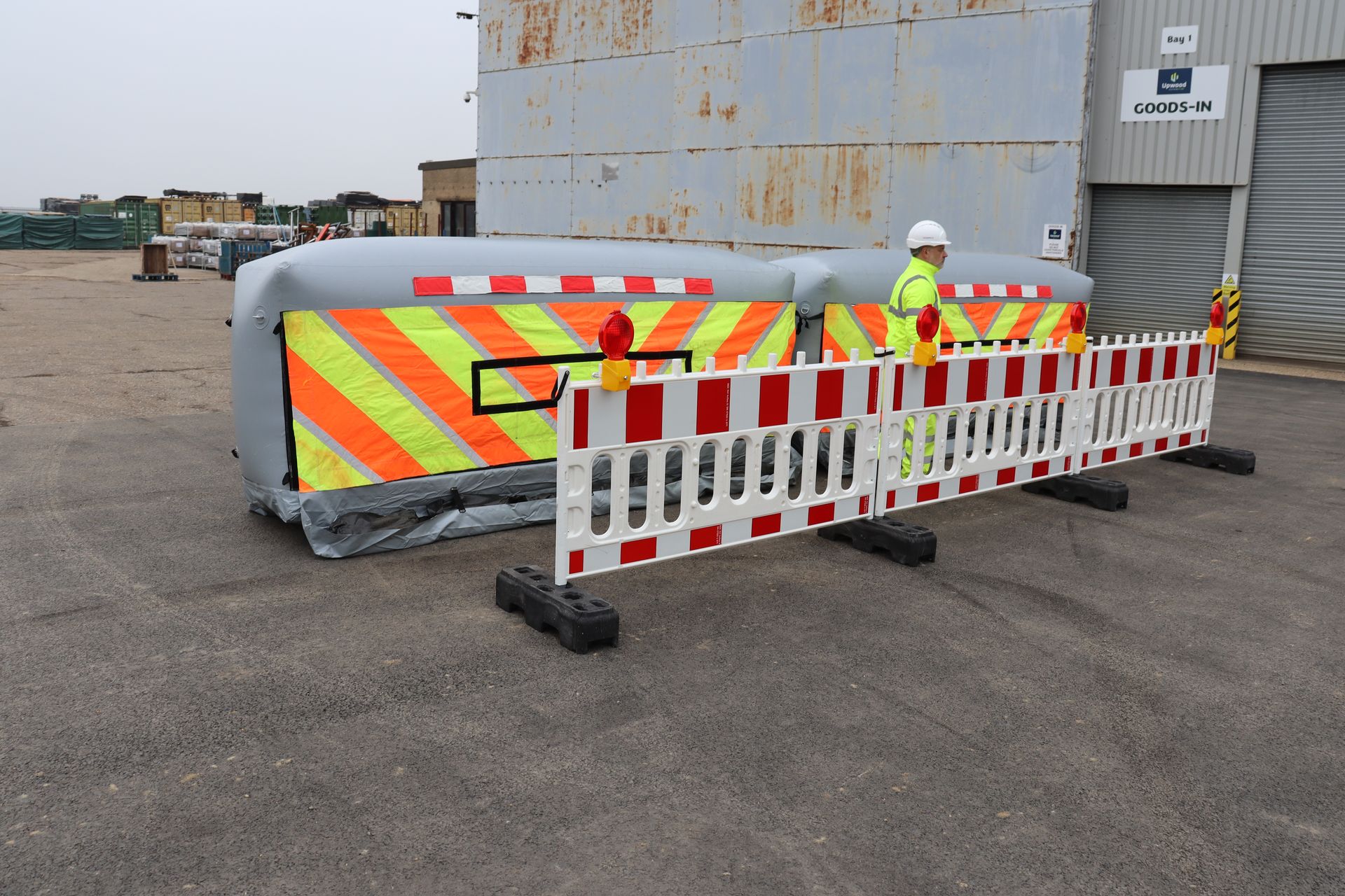 InflatorShield units deployed behind standard road barriers with operative — typical motorway works setup