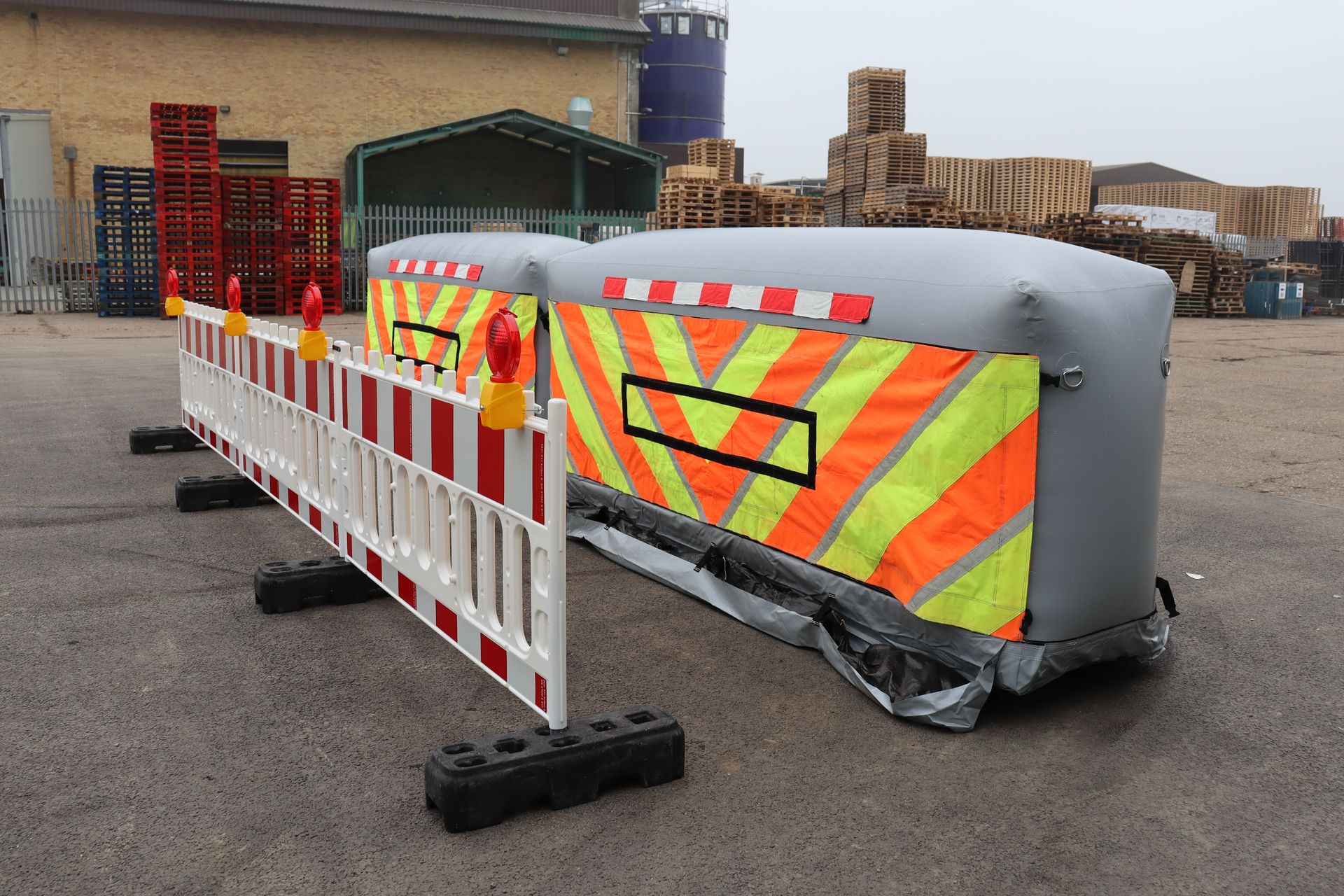 Two InflatorShield units fully deployed alongside Highways England barriers — complete lane closure system