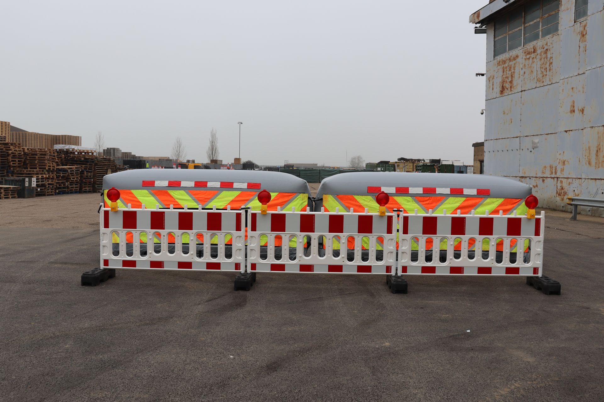 Front-facing view of two InflatorShield units behind road barriers — showing the visual deterrent effect to drivers