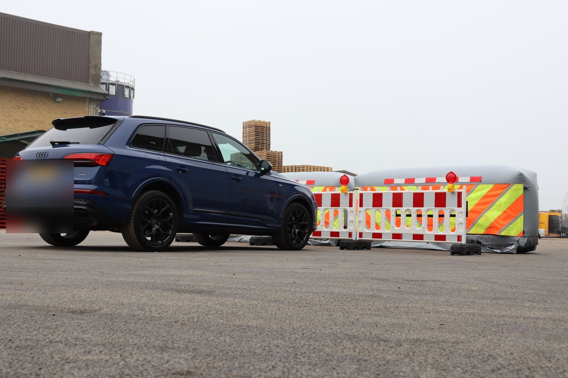 InflatorShield unit next to a car — scale reference showing the unit fills a full traffic lane width